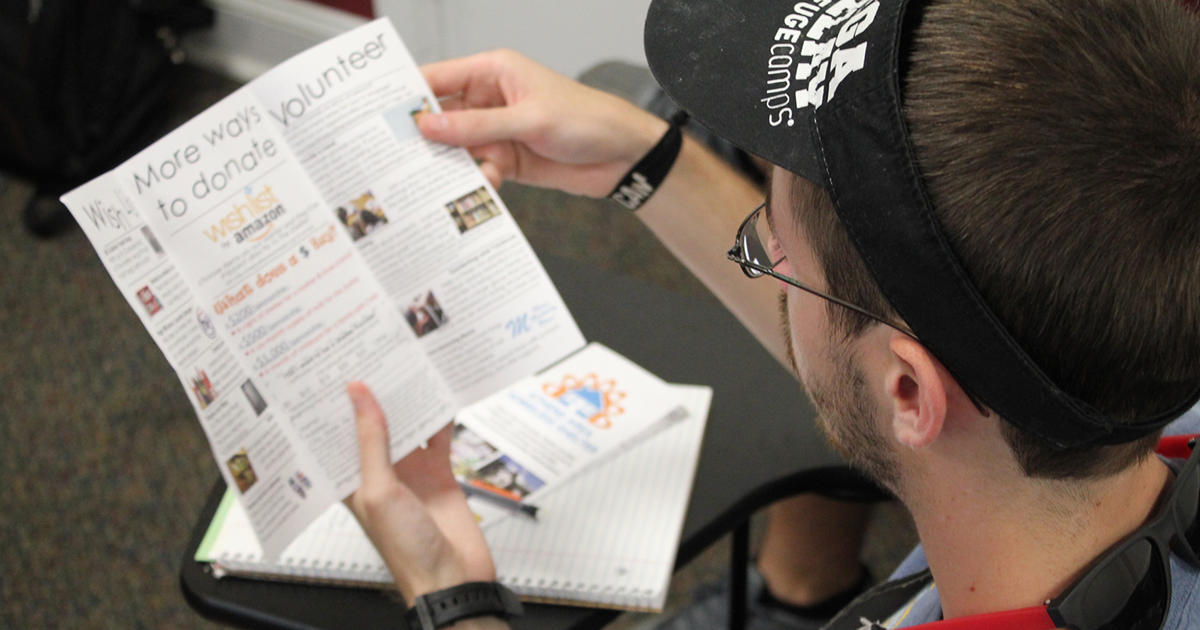 Student looking at brochure.