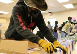 Lemuel “Life” LaRoche, an instructor at the UGA School of Social Work, assists with food distribution in East Athens. (Photo by Laurie Anderson/UGA)
