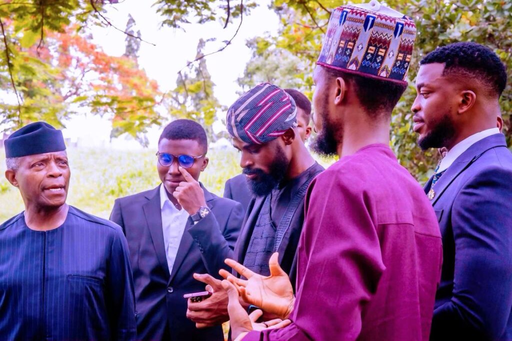 The founder of Chess in Slums, Tunde Onakoya, discussing what the organization does with the Vice President of Nigeria at his VP Lodge in Abuja