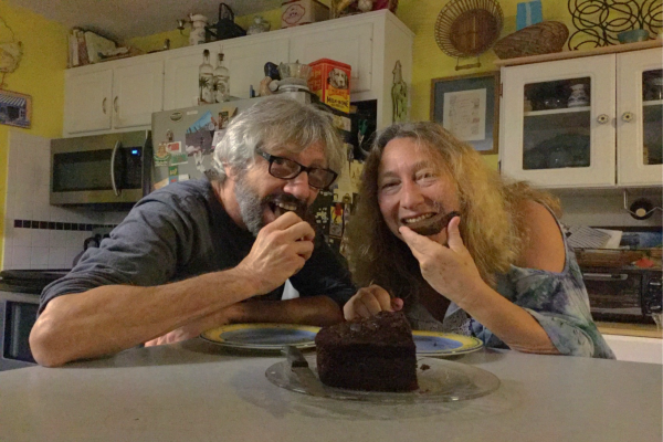 Eddie Glikin and Lisa Anger eating cake together