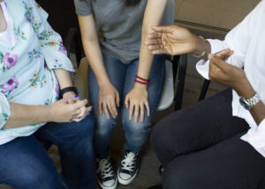People sitting together with faces cropped out